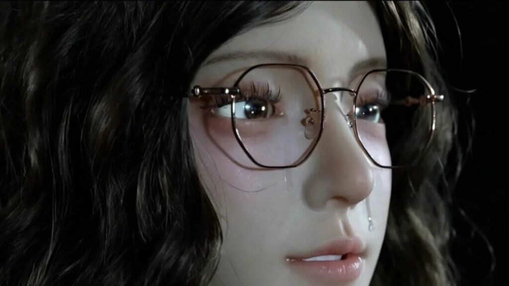 Close-up of the Yansyn-X2 humanoid robot with a real tear rolling down its bionic face, showing capillary microfluidic crying in action.
